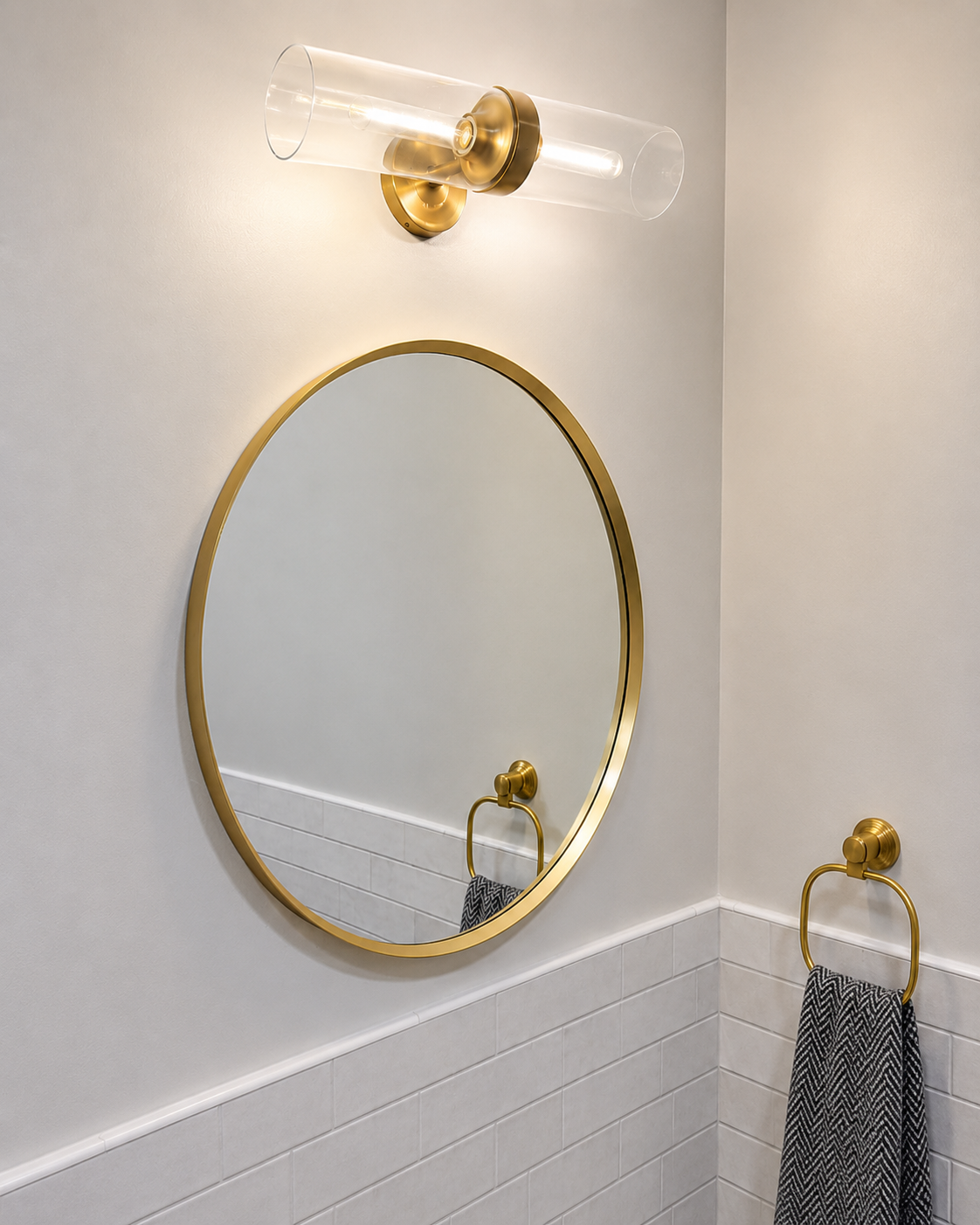 Navy vanity with gold faucet, round mirror, and subway tile wainscoting
