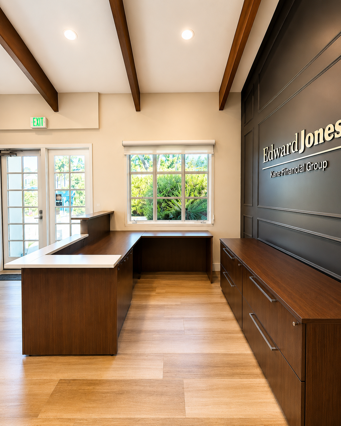Modern office lobby with wood reception desk and Edward Jones branded wall