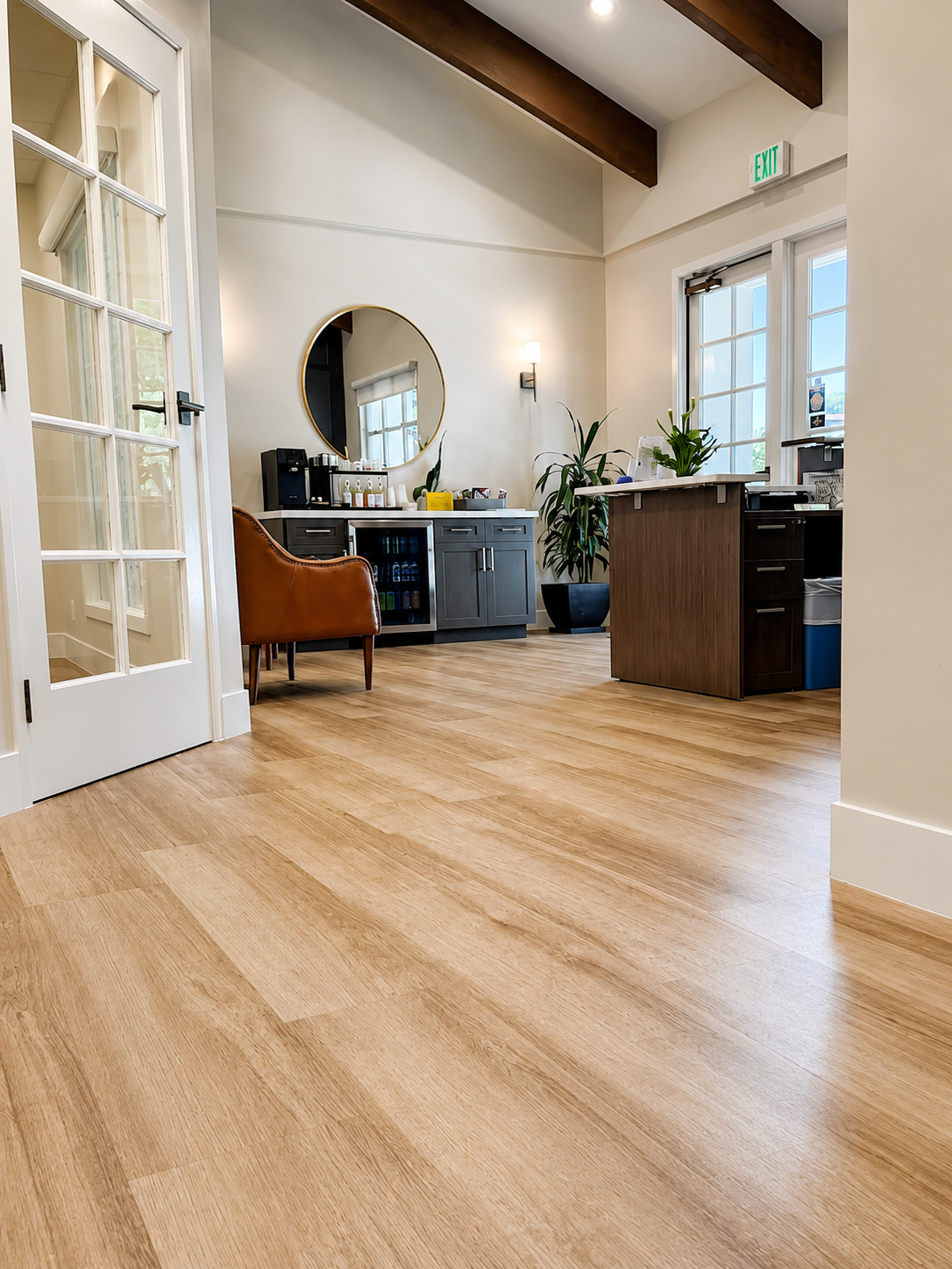 Lobby reception area with wood desk and branded wall signage