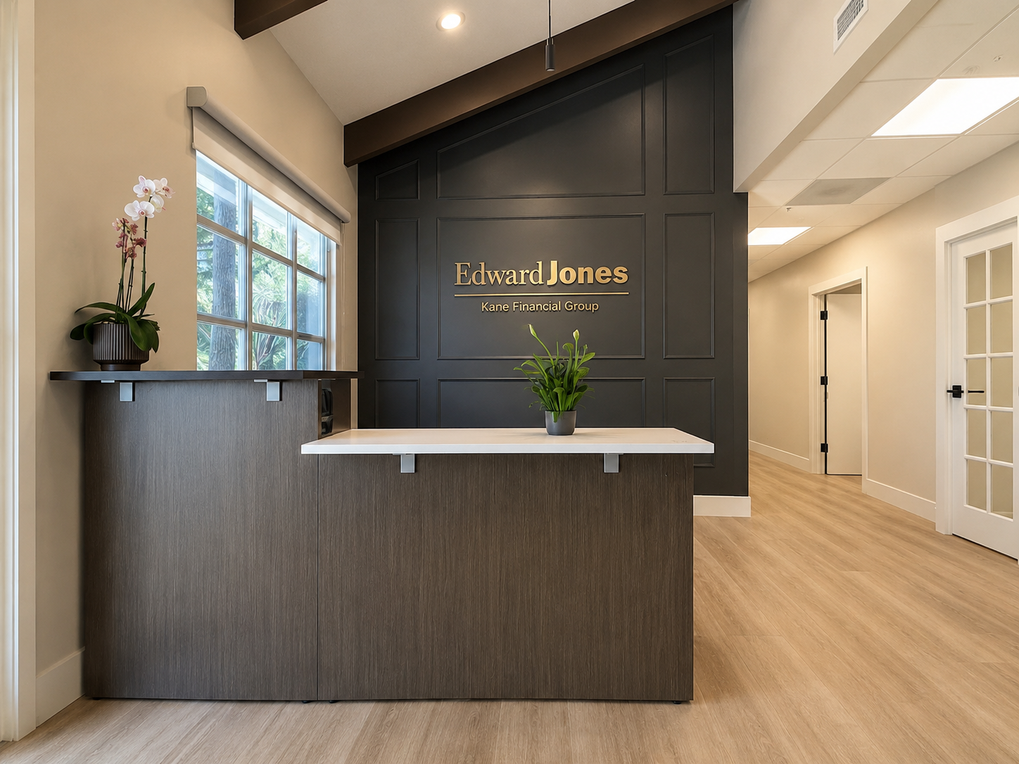 Lobby coffee station with gold-framed mirror and dark cabinetry