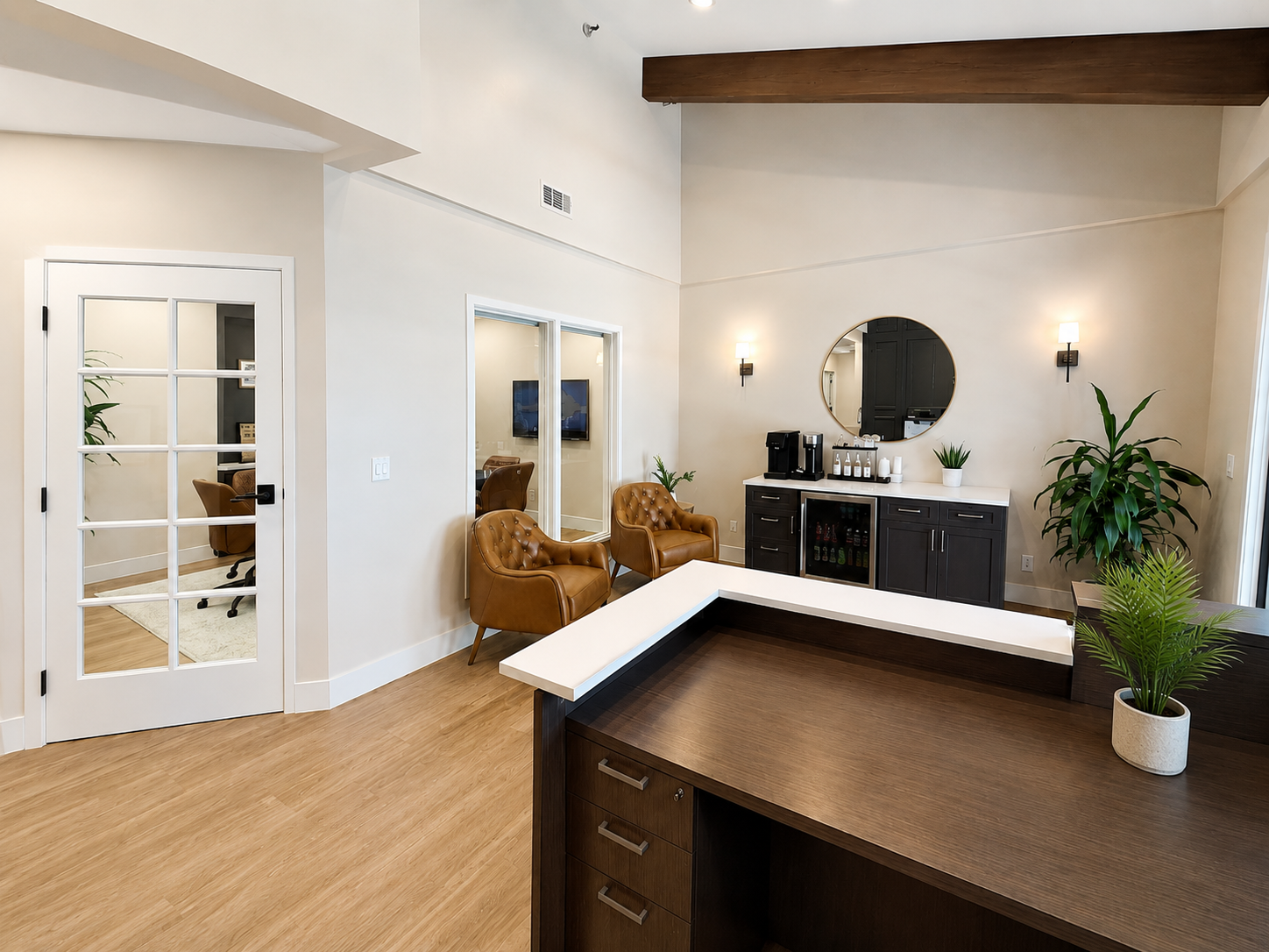Reception area with tufted leather chairs and glass-panel office doors